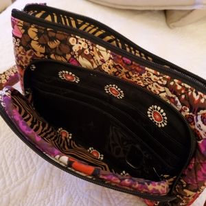 Vera Bradley cross body bag with top zipper opening.